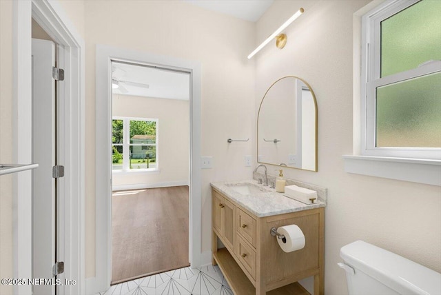 bathroom with vanity, a ceiling fan, and toilet