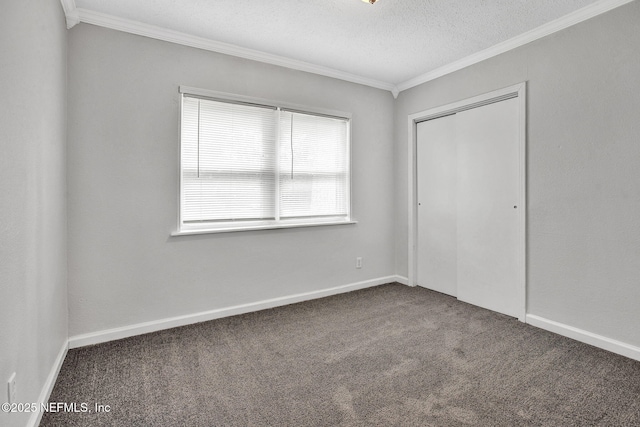 5417 Attleboro St, Jacksonville, FL 32205 - unfurnished bedroom featuring crown molding, carpet, a closet, a textured ceiling, and baseboards