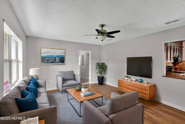 5417 Attleboro St, Jacksonville, FL 32205 - living room featuring a ceiling fan, baseboards, and wood finished floors