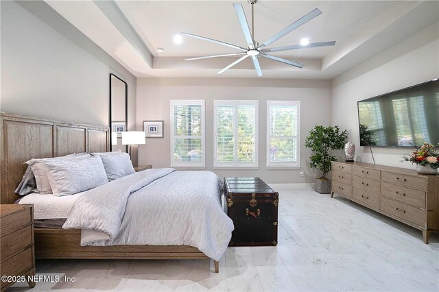 bedroom with a tray ceiling, a ceiling fan, light marble finish flooring, baseboards, and recessed lighting