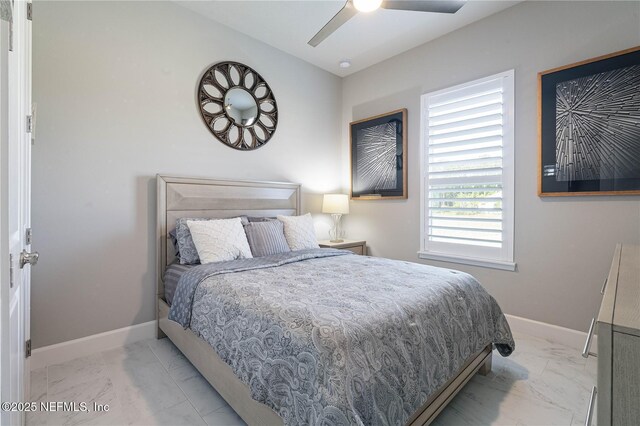 bedroom featuring marble look tile flooring, baseboards, and a ceiling fan