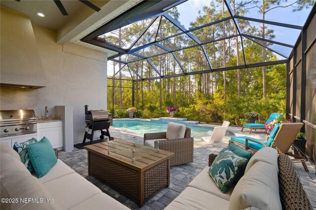 view of patio with exterior kitchen, outdoor lounge area, area for grilling, an outdoor pool, and a sink