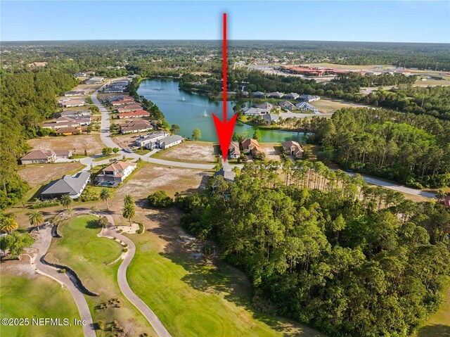 aerial view of property and surrounding area featuring a nearby body of water, nearby suburban area, and a golf club