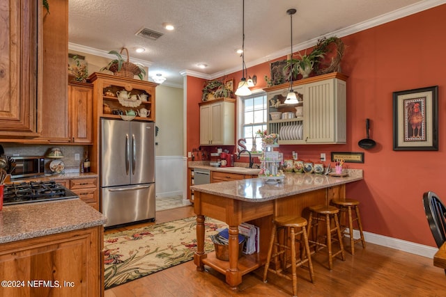 kitchen featuring a sink, open shelves, visible vents, and appliances with stainless steel finishes
