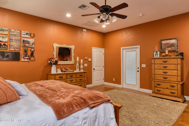 bedroom featuring recessed lighting, baseboards, visible vents, and wood finished floors