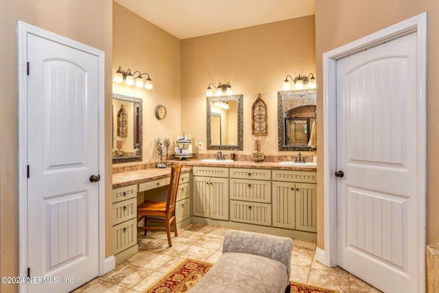 bathroom featuring tile patterned floors, double vanity, and a sink