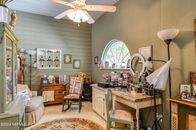 home office with wood walls and a ceiling fan