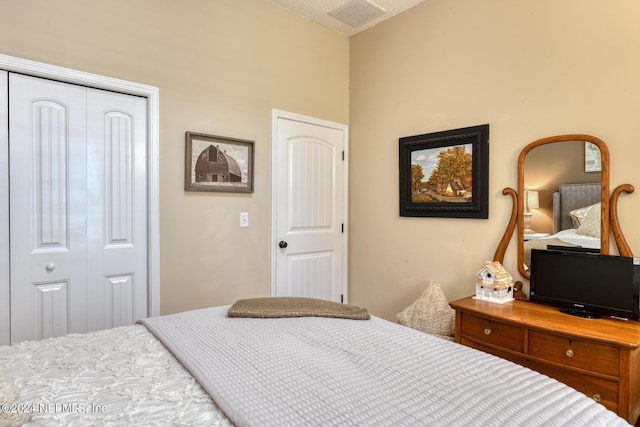 bedroom with a closet and visible vents