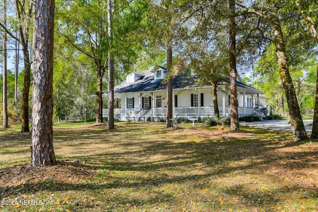cape cod house featuring a porch and a front yard