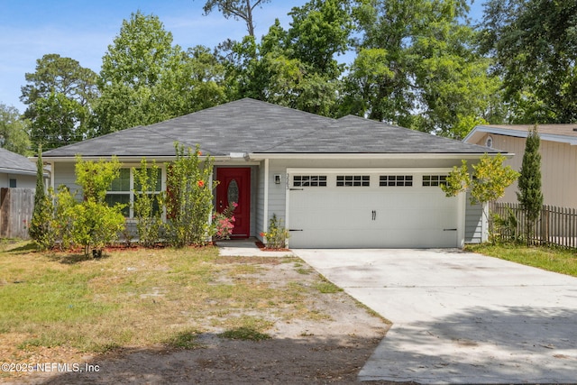 ranch-style home with driveway, a shingled roof, a garage, and fence