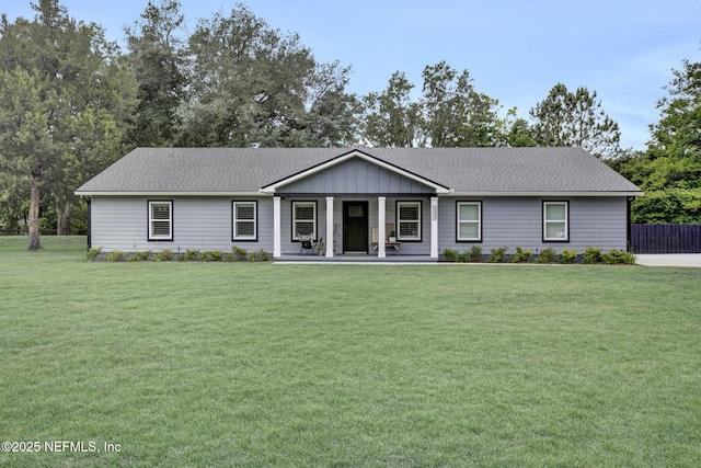 single story home featuring a porch, a front lawn, board and batten siding, and roof with shingles