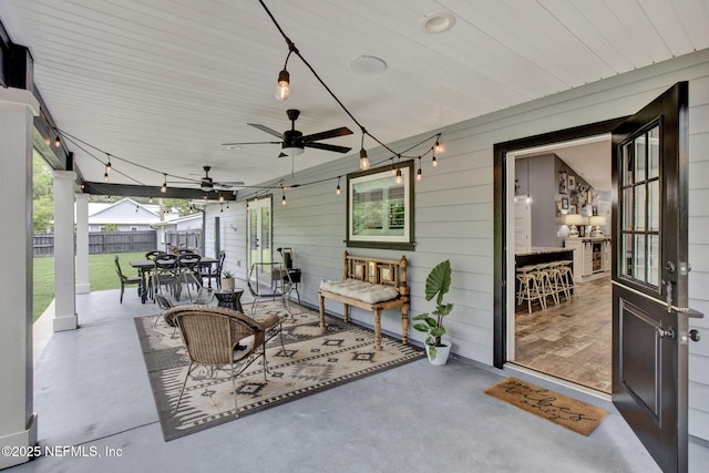 view of patio / terrace featuring outdoor dining space, fence, and ceiling fan