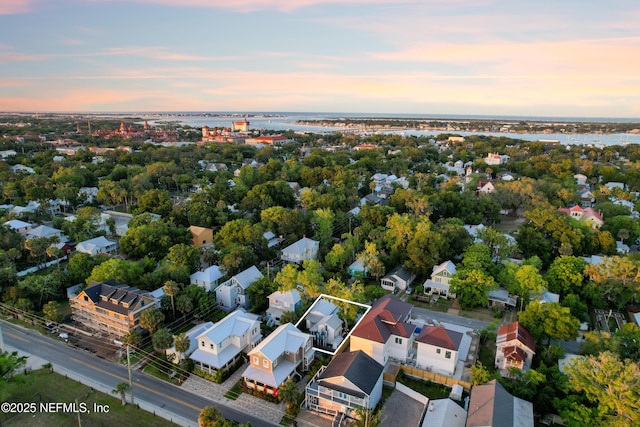 70 Weeden St + Guest House, Unit Guest House, Saint Augustine, FL 32084 - aerial view at dusk featuring a water view and a residential view