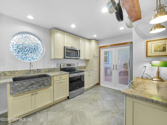 70 Weeden St + Guest House, Unit Guest House, Saint Augustine, FL 32084 - kitchen with french doors, a healthy amount of sunlight, a sink, appliances with stainless steel finishes, and cream cabinets