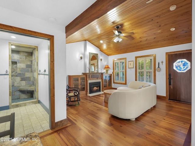 70 Weeden St + Guest House, Unit Guest House, Saint Augustine, FL 32084 - living room with baseboards, a glass covered fireplace, ceiling fan, wood finished floors, and vaulted ceiling with beams