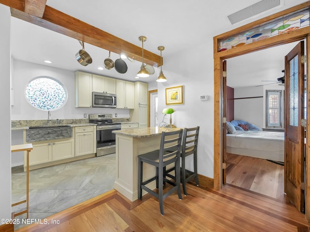 70 Weeden St + Guest House, Unit Guest House, Saint Augustine, FL 32084 - kitchen with light wood-style floors, ceiling fan, visible vents, and appliances with stainless steel finishes
