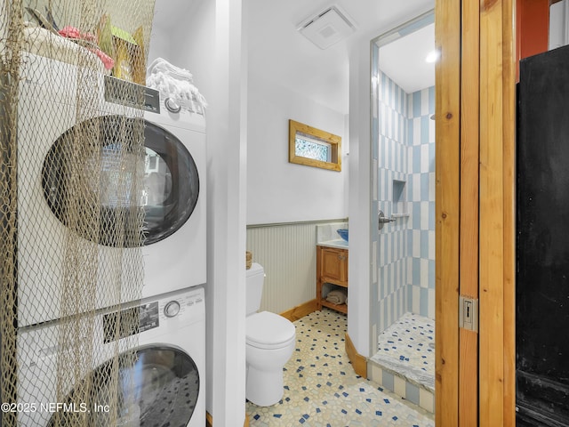 70 Weeden St + Guest House, Unit Guest House, Saint Augustine, FL 32084 - full bathroom with toilet, stacked washer and dryer, a wainscoted wall, a shower stall, and vanity