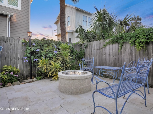 70 Weeden St + Guest House, Unit Guest House, Saint Augustine, FL 32084 - patio terrace at dusk featuring a fire pit and a fenced backyard