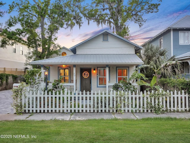 70 Weeden St + Guest House, Unit Guest House, Saint Augustine, FL 32084 - view of front of house with metal roof, a fenced front yard, and covered porch