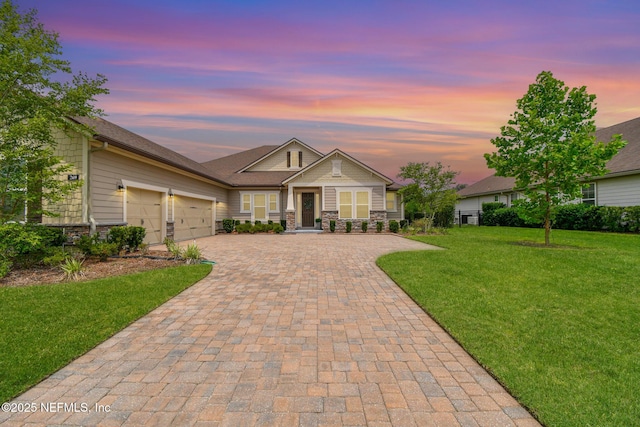 269 Fremont Ave, Saint Augustine, FL 32095 - view of front facade featuring decorative driveway, stone siding, a garage, and a front yard