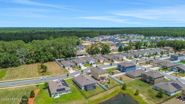 bird's eye view with a wooded view and a residential view