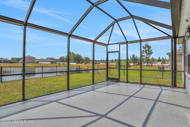 unfurnished sunroom with a water view and a residential view