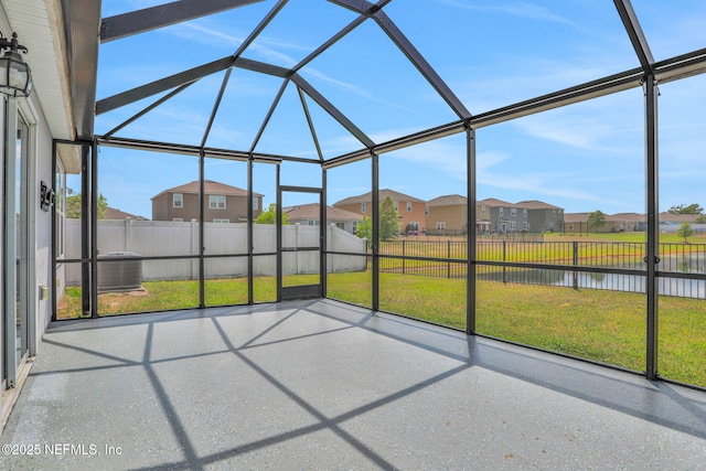 unfurnished sunroom with a water view and a residential view