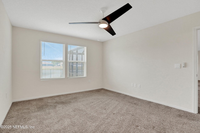 unfurnished room featuring carpet flooring, baseboards, and a ceiling fan