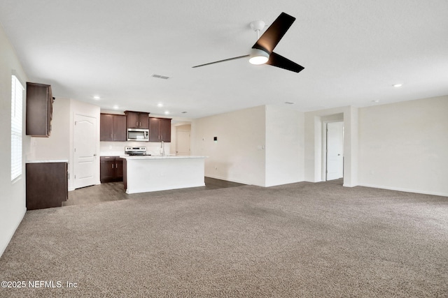 unfurnished living room with a ceiling fan, recessed lighting, visible vents, and carpet floors
