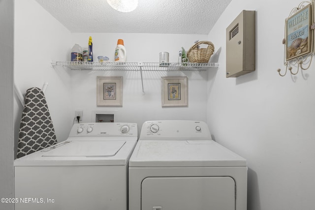 890 A1A Beach Blvd Unit 39, Saint Augustine, FL 32080 - washroom with washing machine and dryer and a textured ceiling