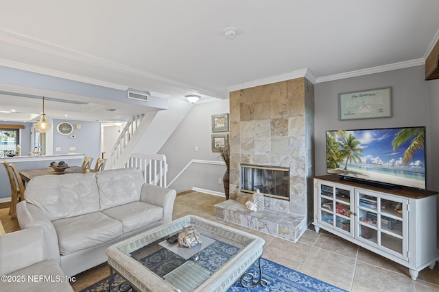 890 A1A Beach Blvd Unit 39, Saint Augustine, FL 32080 - living area with stairway, ornamental molding, a tiled fireplace, and tile patterned flooring