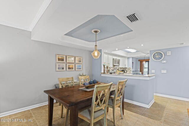 890 A1A Beach Blvd Unit 39, Saint Augustine, FL 32080 - dining room with a tray ceiling, recessed lighting, and light tile patterned floors