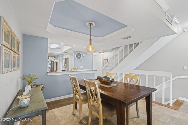 890 A1A Beach Blvd Unit 39, Saint Augustine, FL 32080 - dining room with a raised ceiling, stairs, and light tile patterned flooring