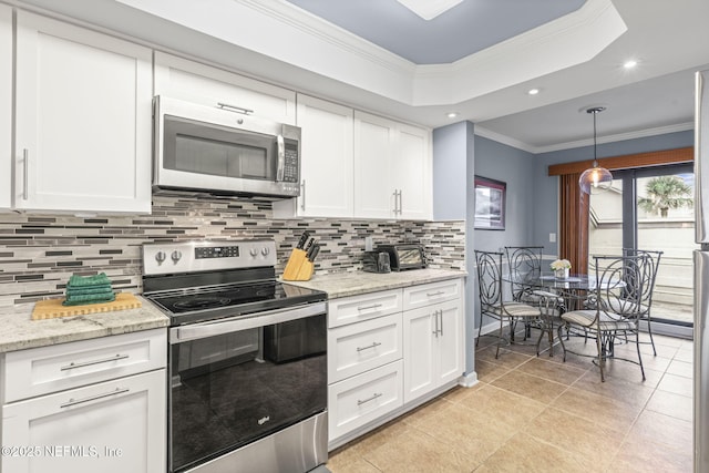 890 A1A Beach Blvd Unit 39, Saint Augustine, FL 32080 - kitchen with appliances with stainless steel finishes, ornamental molding, backsplash, white cabinets, and recessed lighting