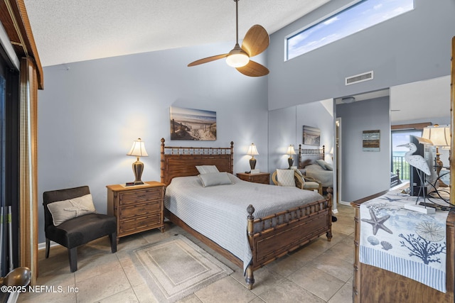 890 A1A Beach Blvd Unit 39, Saint Augustine, FL 32080 - bedroom featuring multiple windows, high vaulted ceiling, a ceiling fan, access to exterior, and a textured ceiling