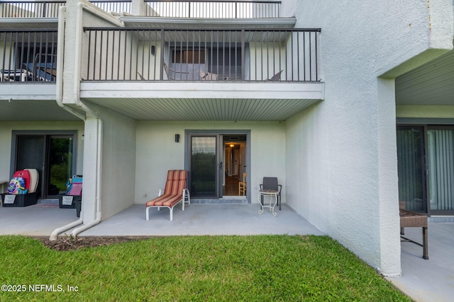 890 A1A Beach Blvd Unit 39, Saint Augustine, FL 32080 - back of property with a balcony, stucco siding, and a patio area