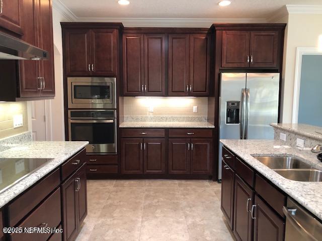71 Utina Way, Saint Augustine, FL 32084 - kitchen with a sink, ornamental molding, under cabinet range hood, and appliances with stainless steel finishes