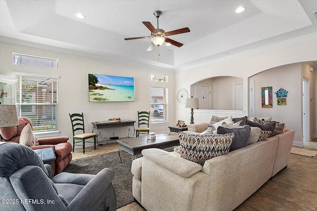 71 Utina Way, Saint Augustine, FL 32084 - tiled living room with ceiling fan, a raised ceiling, crown molding, and arched walkways