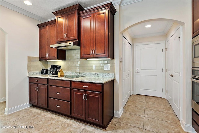 71 Utina Way, Saint Augustine, FL 32084 - kitchen featuring under cabinet range hood, crown molding, decorative backsplash, and arched walkways