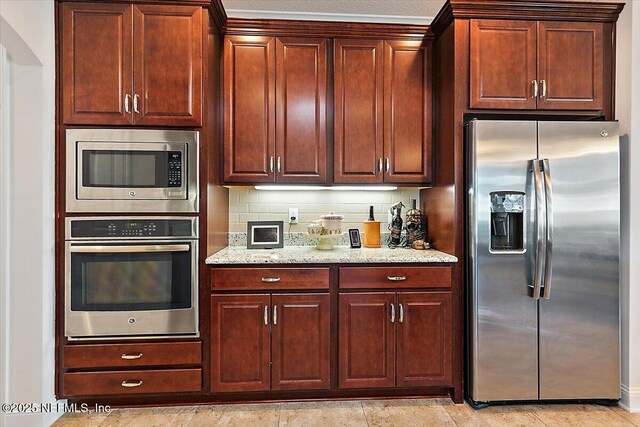 71 Utina Way, Saint Augustine, FL 32084 - kitchen featuring light stone countertops, tasteful backsplash, and appliances with stainless steel finishes