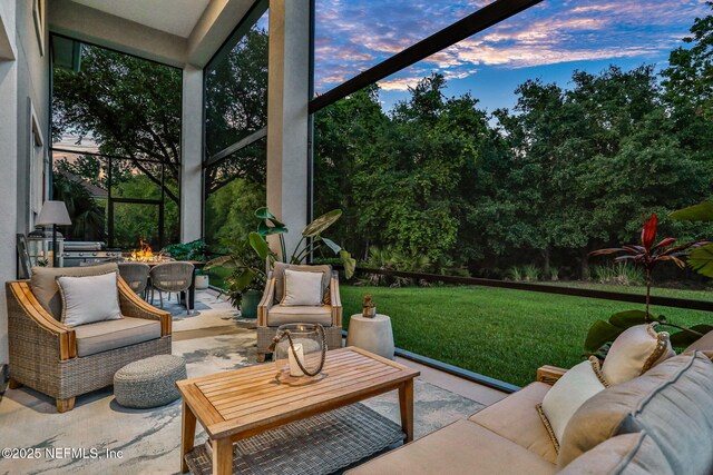 105 Calle Norte, Saint Augustine, FL 32095 - patio terrace at dusk with an outdoor living space with a fire pit and a yard