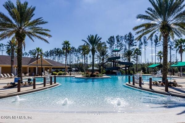 community pool featuring a water slide
