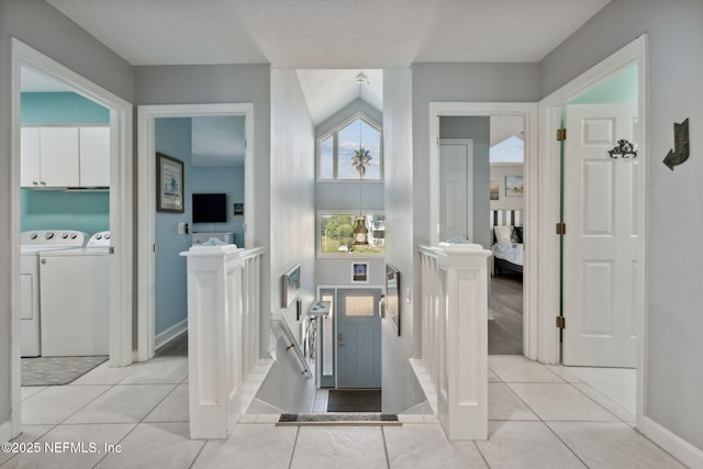 2122 S Fletcher Ave, Fernandina Beach, FL 32034 - hallway with light tile patterned floors, baseboards, and separate washer and dryer