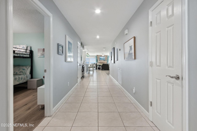 2122 S Fletcher Ave, Fernandina Beach, FL 32034 - corridor with baseboards, light tile patterned floors, and recessed lighting