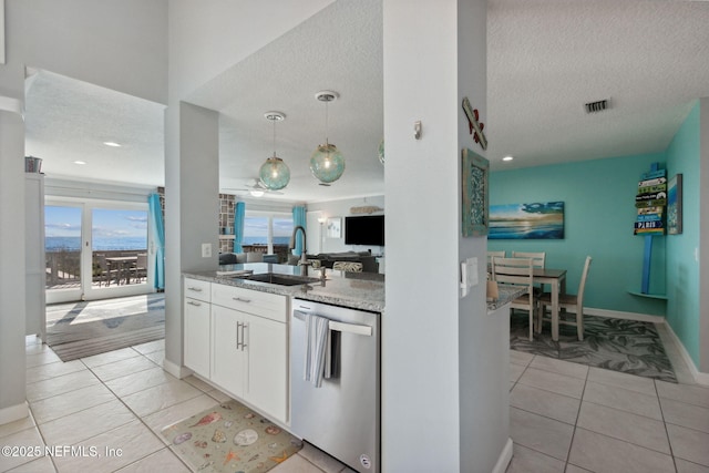 2122 S Fletcher Ave, Fernandina Beach, FL 32034 - kitchen with a sink, stainless steel dishwasher, a textured ceiling, and light tile patterned floors