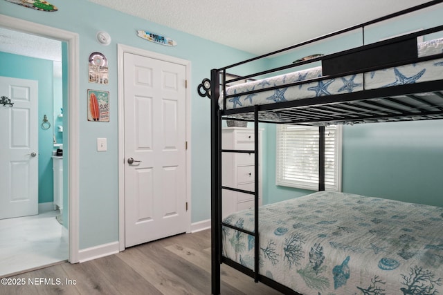 2122 S Fletcher Ave, Fernandina Beach, FL 32034 - bedroom with a textured ceiling, wood finished floors, and baseboards