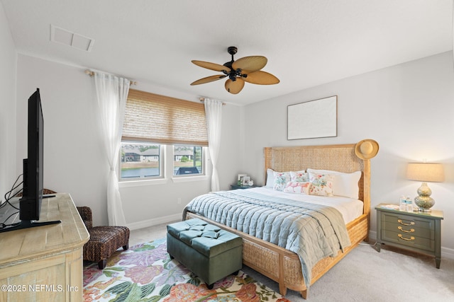 bedroom featuring light carpet, baseboards, a ceiling fan, and visible vents
