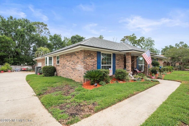2632 Loopridge Dr, Orange Park, FL 32065 - view of front facade featuring brick siding, a front yard, concrete driveway, and a shingled roof