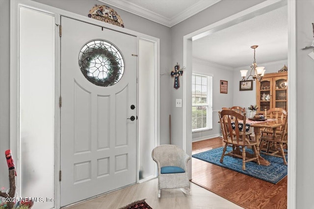 2632 Loopridge Dr, Orange Park, FL 32065 - foyer with wood finished floors, a chandelier, crown molding, and baseboards