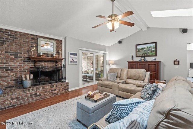 2632 Loopridge Dr, Orange Park, FL 32065 - living room with a ceiling fan, wood finished floors, a brick fireplace, and a skylight